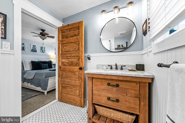 a bathroom with a sink a vanity and a mirror