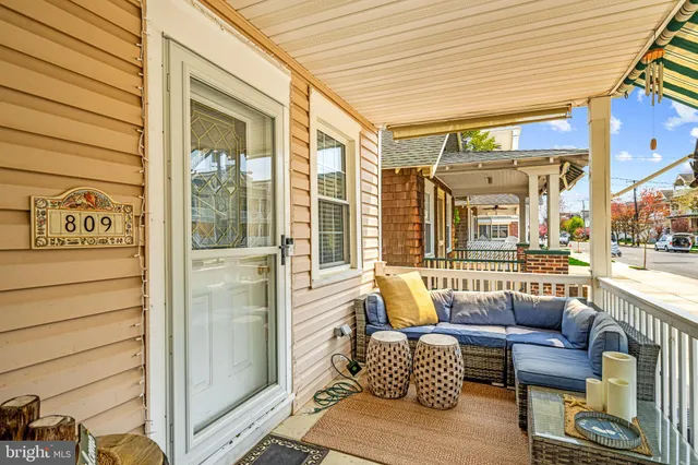 a balcony with furniture and a potted plant