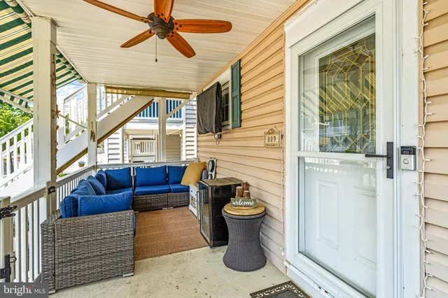 a living room with furniture a flat screen tv and a window