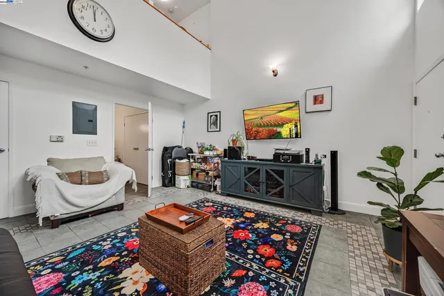 a living room with furniture a rug and a flat screen tv