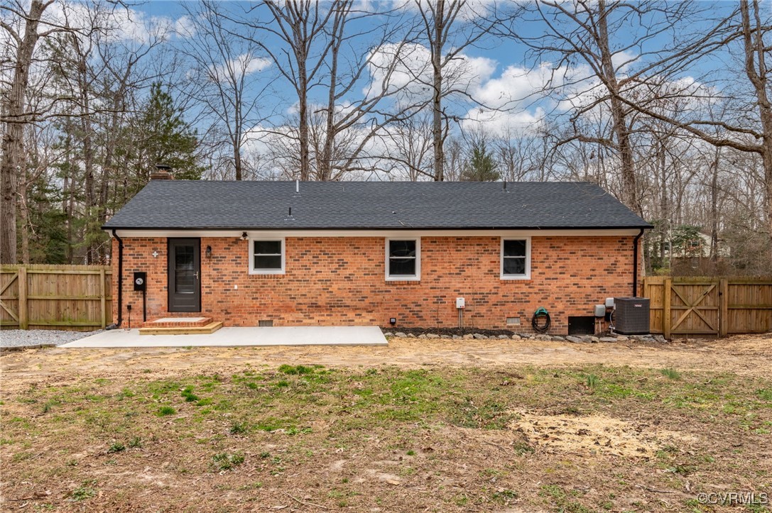 102 Riva Ridge Circle Sandston, VA 23150 - Photo 20 of 23 Rear view of house with brick siding, a patio, a c