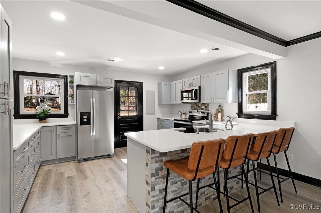 102 Riva Ridge Circle Sandston, VA 23150 - Photo 6 of 23 Kitchen featuring gray cabinetry, a breakfast bar