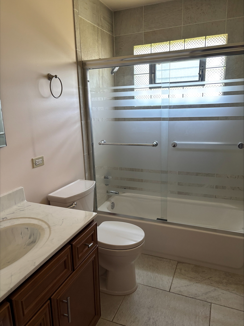 21W246 Audubon Road Lombard, IL 60148 - Photo 12 of 19 a bathroom with a sink a toilet and shower