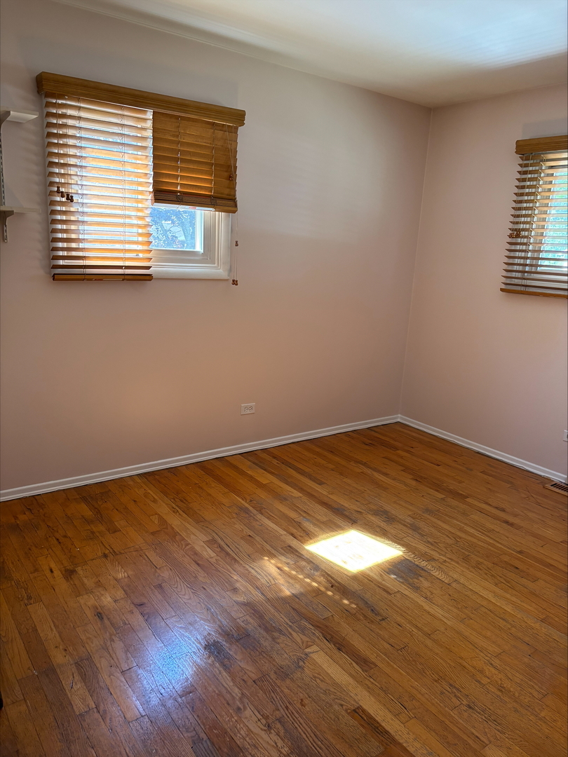 21W246 Audubon Road Lombard, IL 60148 - Photo 14 of 19 a view of a room with wooden floor and a window