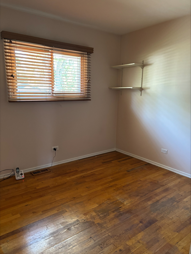 21W246 Audubon Road Lombard, IL 60148 - Photo 15 of 19 wooden floor in an empty room with a window