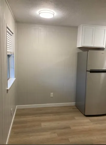 a view of a closet with wooden floor