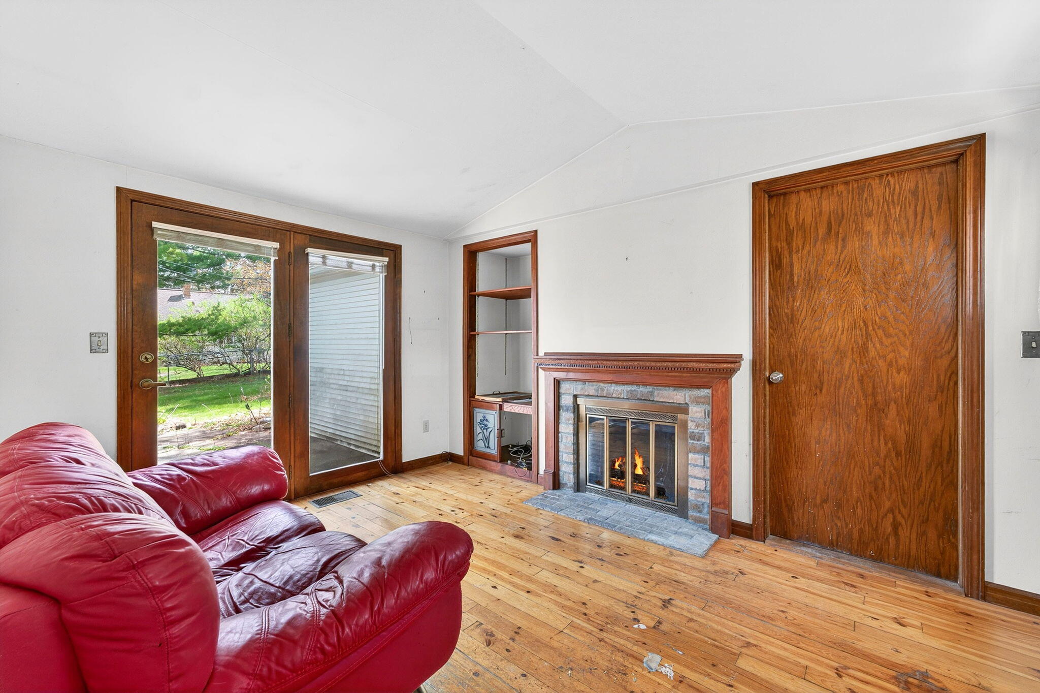 980 South Webster Avenue Brookfield, WI 53005 - Photo 8 of 29 4 Season Den with Natural Wood Floors and Fireplace exits to Backyard Patio.