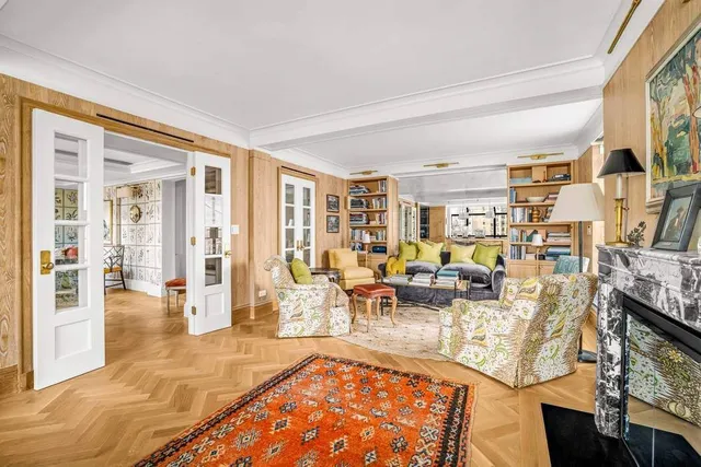 a view of a kitchen with kitchen island a counter top space appliances and a ceiling fan