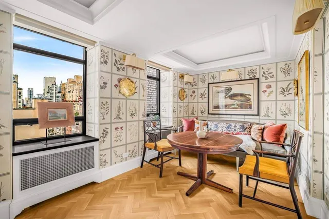 a living room with fireplace furniture and a large window