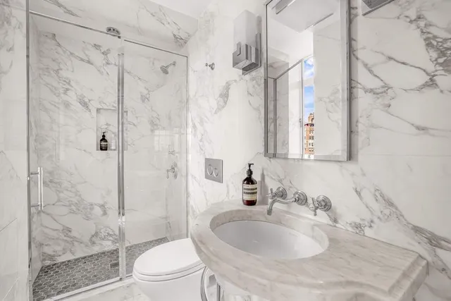 a spacious bedroom with a bed and a large window