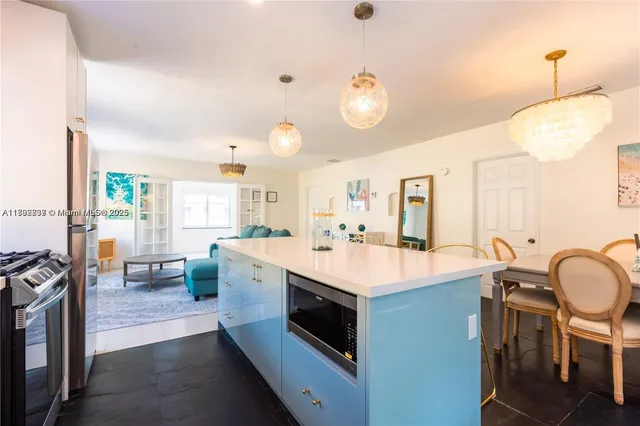 a large white kitchen with a large window