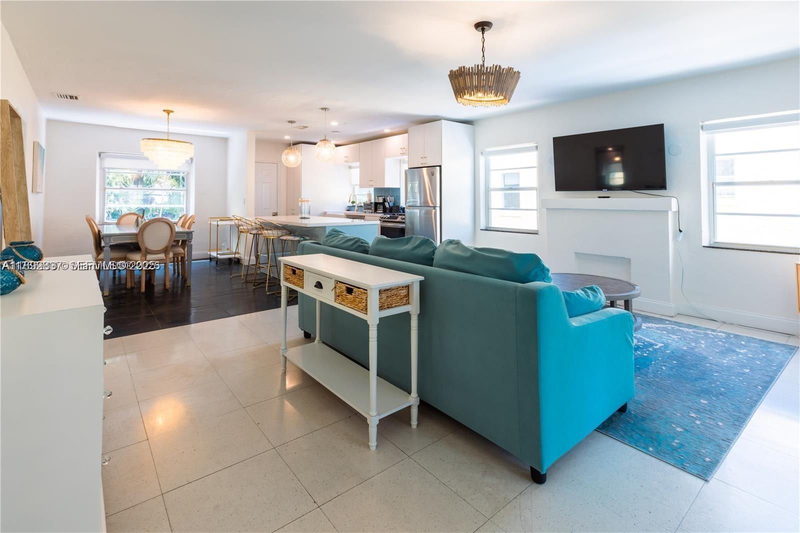 426 Northeast 26th Street, Unit 1 Miami, FL 33137 - Photo 20 of 23 a living room with furniture and a flat screen tv