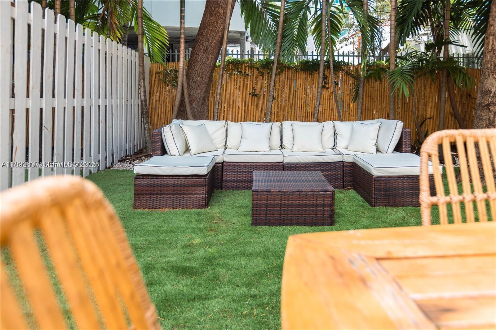 426 Northeast 26th Street, Unit 1 Miami, FL 33137 - Photo 6 of 23 a view of a patio with couches chairs and a table and chairs