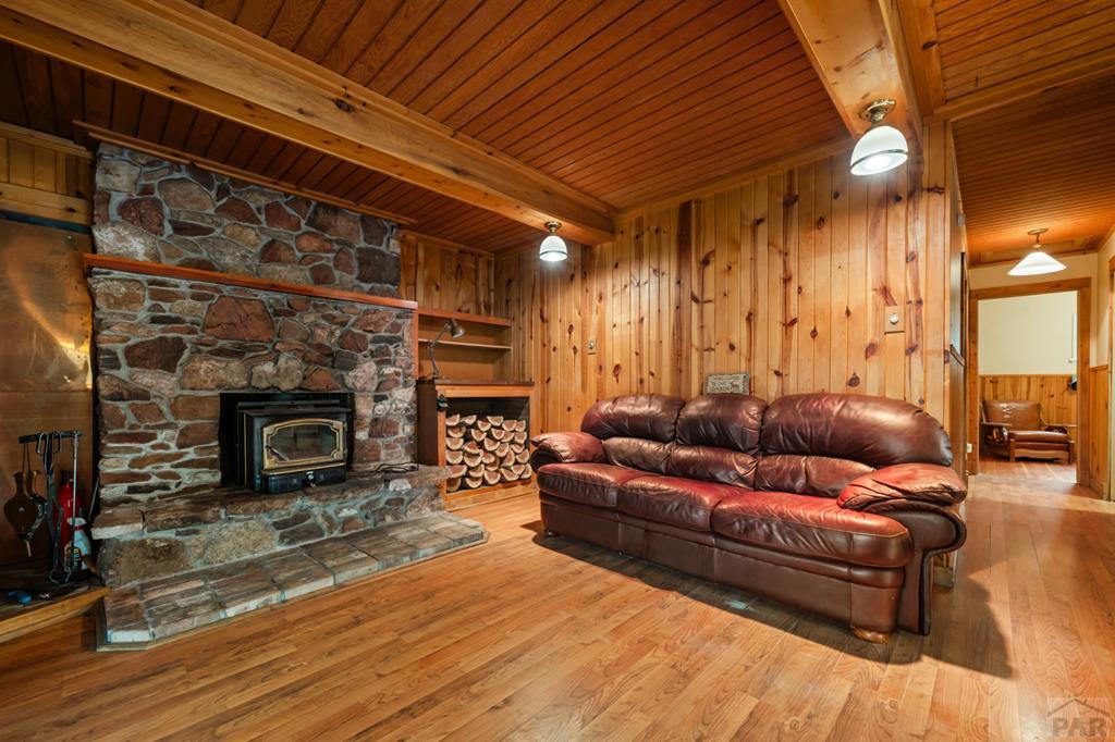 9600 Middle Creek Canyon Road Beulah, CO 81023 - Photo 13 of 50 a living room with furniture and a fireplace
