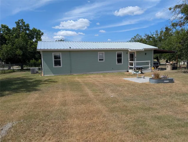 a backyard of a house with yard and garage