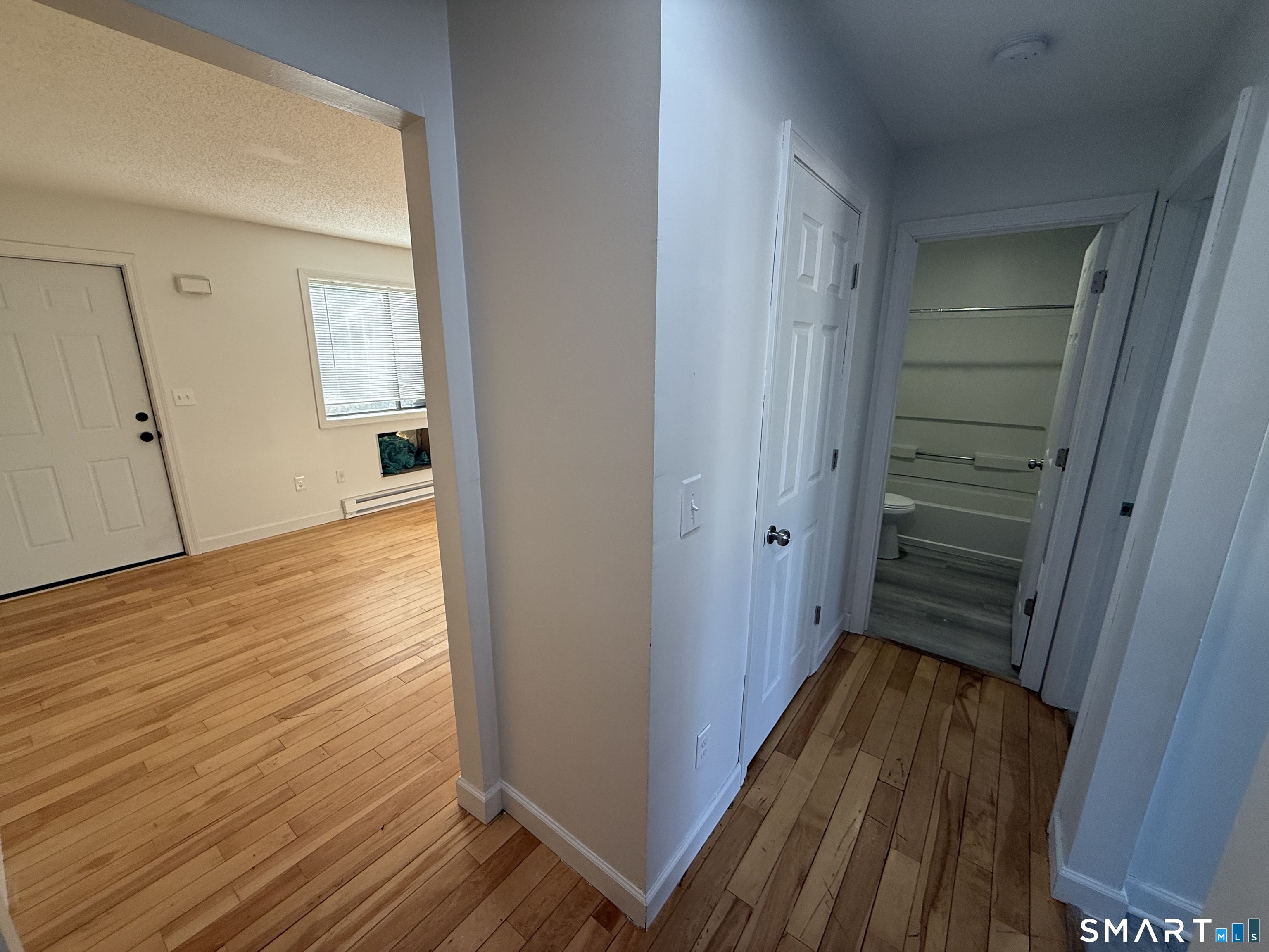 264 Scott Road, Unit 7 Waterbury, CT 06705 - Photo 6 of 10 a view of a hallway with wooden floor and staircase