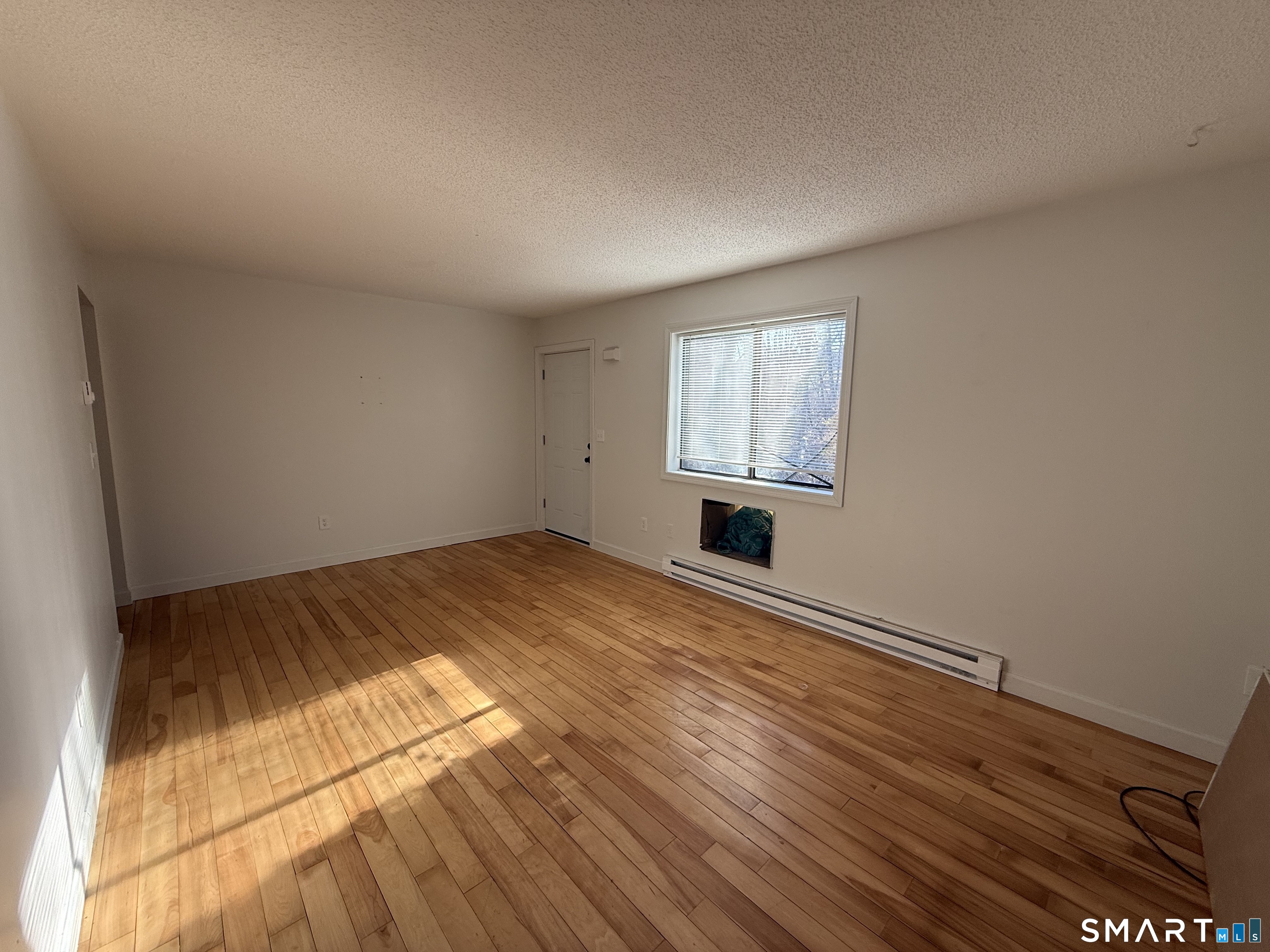 264 Scott Road, Unit 7 Waterbury, CT 06705 - Photo 8 of 10 a view of empty room with wooden floor