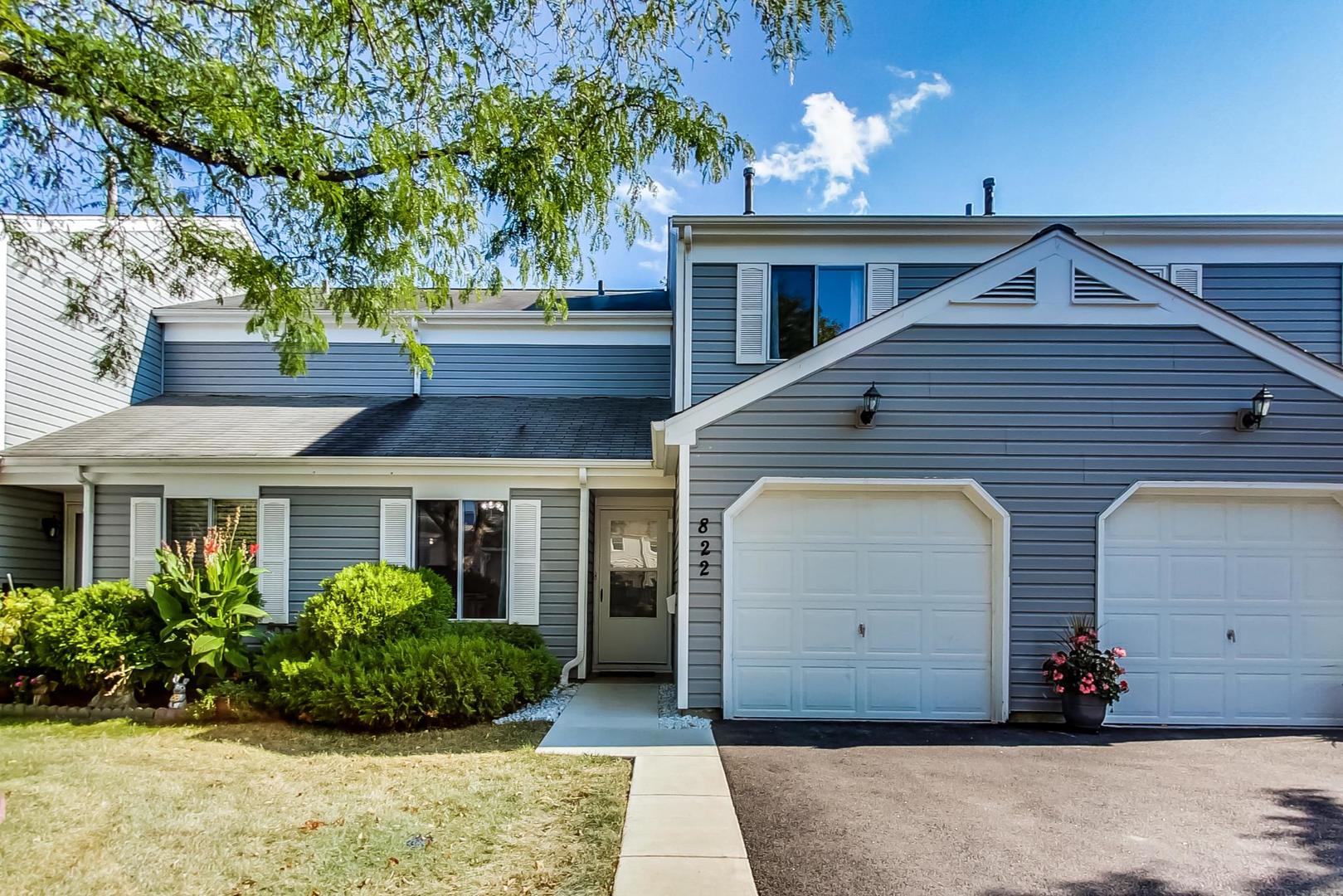822 Minnesota Circle Carol Stream, IL 60188 - Photo 1 of 14 a front view of a house with garden