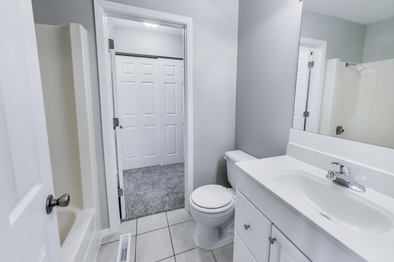822 Minnesota Circle Carol Stream, IL 60188 - Photo 7 of 14 a bathroom with a granite countertop sink toilet and shower