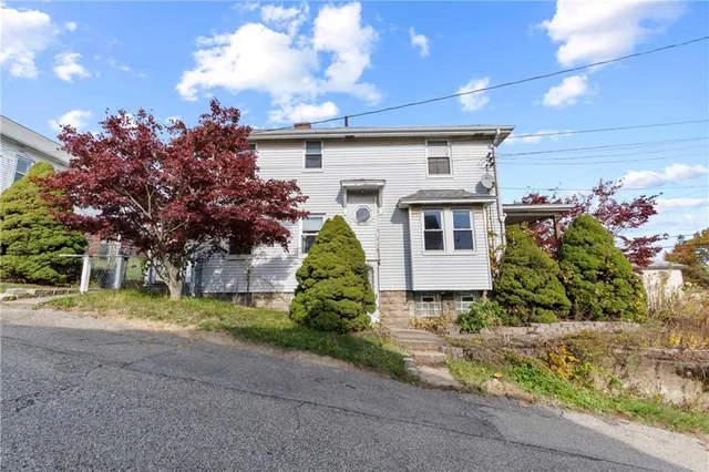 a front view of a house with a yard and a garage