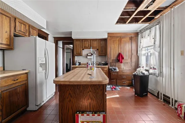 a kitchen with a refrigerator and a stove
