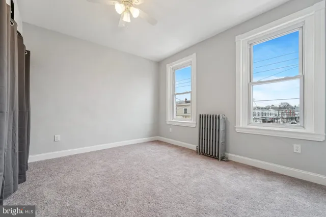 an empty room with windows and closet
