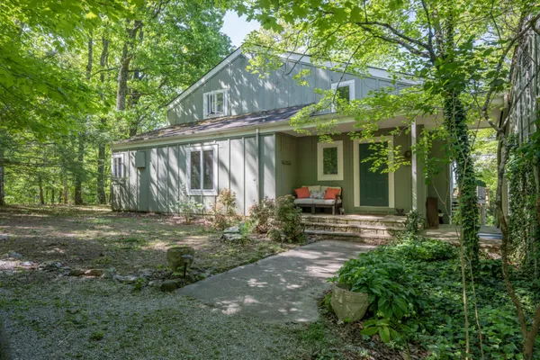a view of a house with backyard and sitting area
