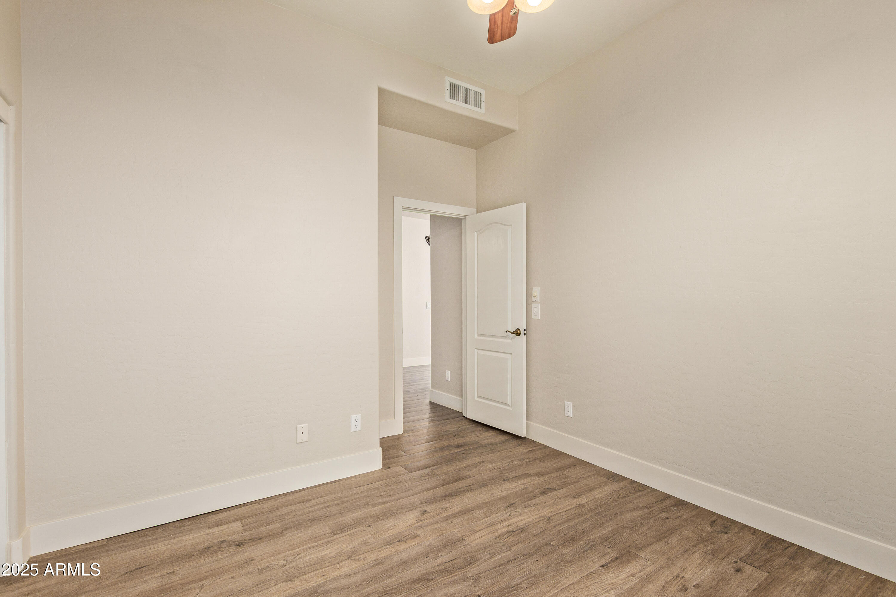 3060 North Ridgecrest, Unit 171 Mesa, AZ 85207 - Photo 12 of 31 a view of an empty room with wooden floor