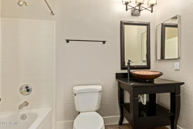 a bathroom with a sink a toilet and bathtub