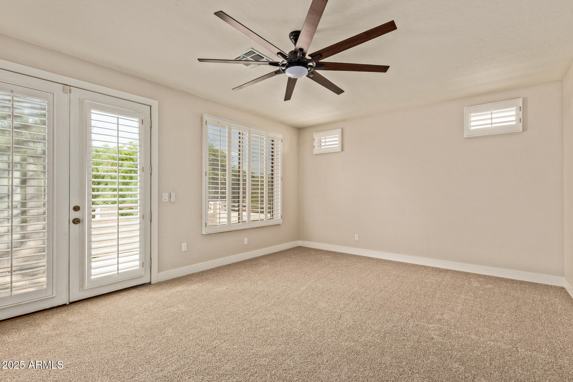 3060 North Ridgecrest, Unit 171 Mesa, AZ 85207 - Photo 14 of 31 an empty room with windows and fan