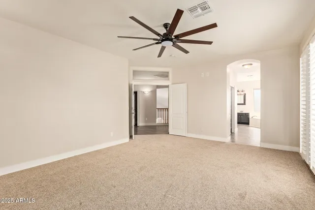 a view of a livingroom with a ceiling fan and window