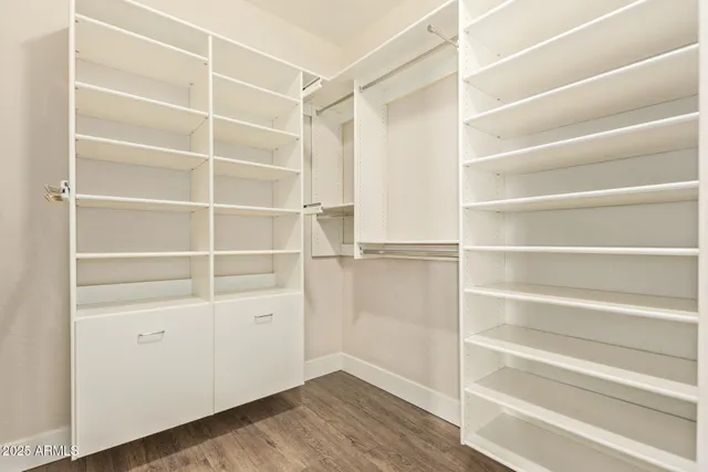 a view of walk in closet with empty racks