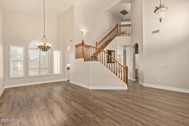 a view of a room with wooden floor and windows