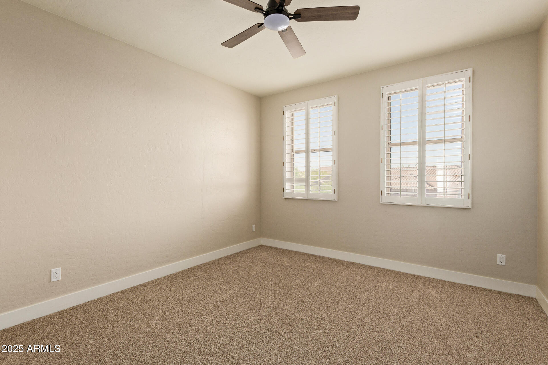 3060 North Ridgecrest, Unit 171 Mesa, AZ 85207 - Photo 22 of 31 an empty room with a window and a fan