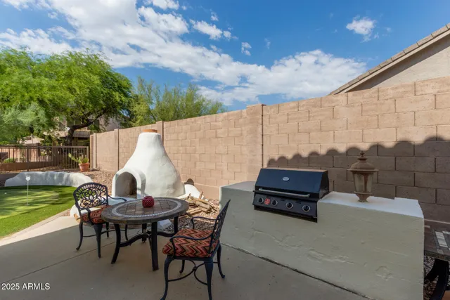 a view of a house with swimming pool and sitting area