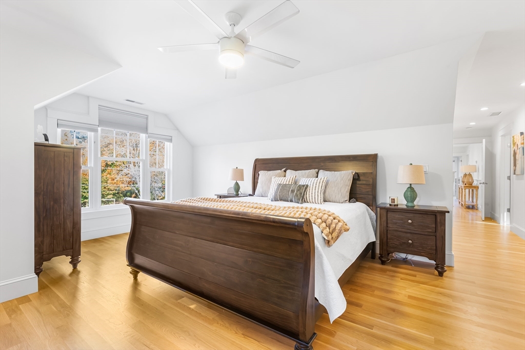 7 Heather Drive Andover, MA 01810 - Photo 21 of 42 a bedroom with a large bed and a chandelier