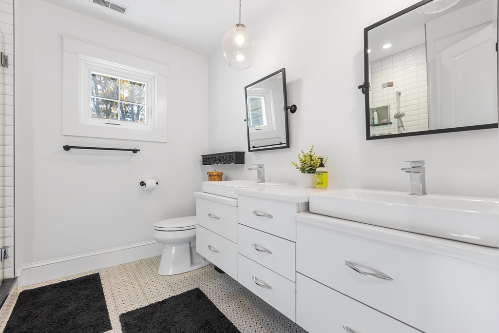 7 Heather Drive Andover, MA 01810 - Photo 23 of 42 a bathroom with a toilet sink and mirror