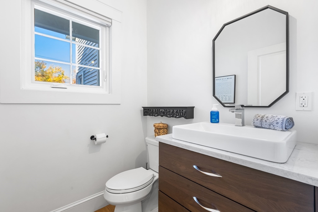 7 Heather Drive Andover, MA 01810 - Photo 35 of 42 a bathroom with a sink a toilet and mirror