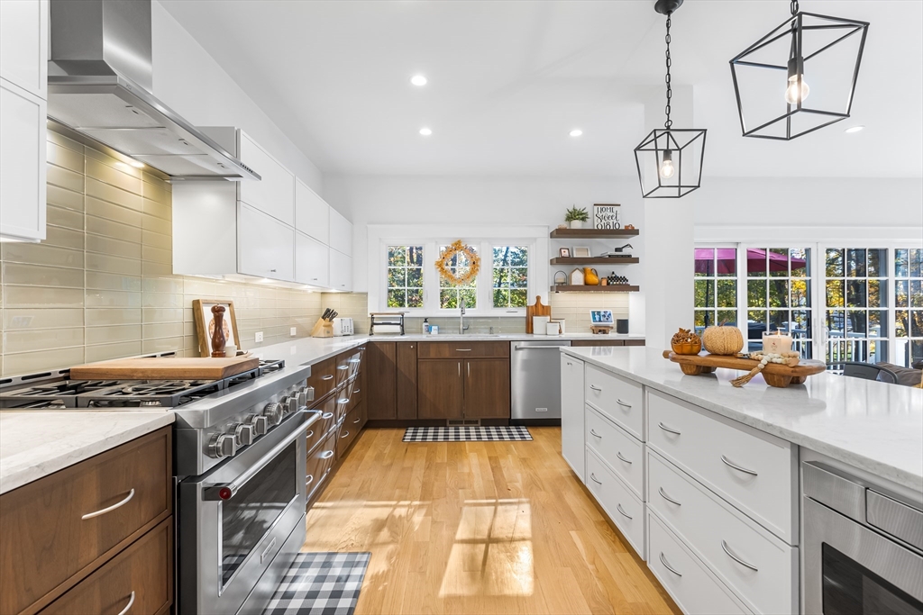 7 Heather Drive Andover, MA 01810 - Photo 8 of 42 a kitchen with stainless steel appliances granite countertop a stove a sink and cabinets