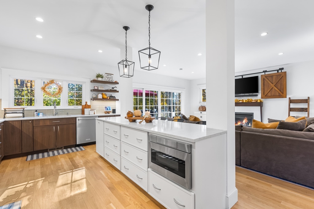 7 Heather Drive Andover, MA 01810 - Photo 10 of 42 a kitchen that has a lot of cabinets in it and wooden floors