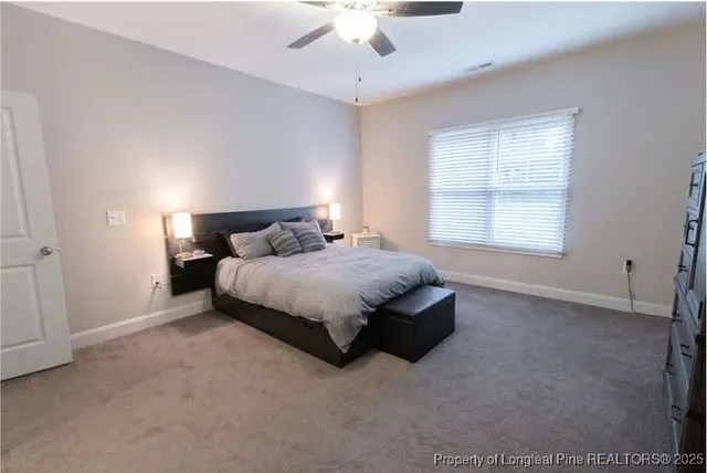 a bedroom with a bed lamp and window