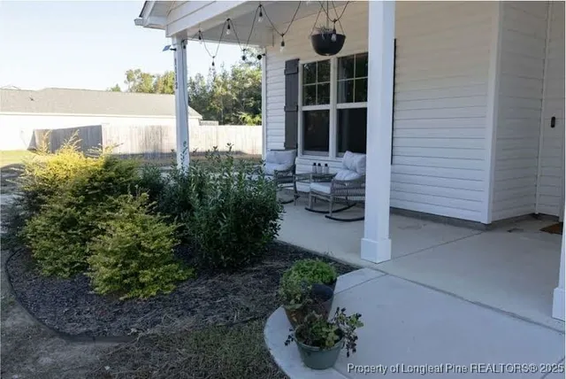 a front view of a house with a garden and plants