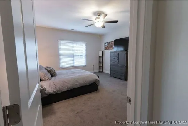 a spacious bedroom with a bed and a chandelier
