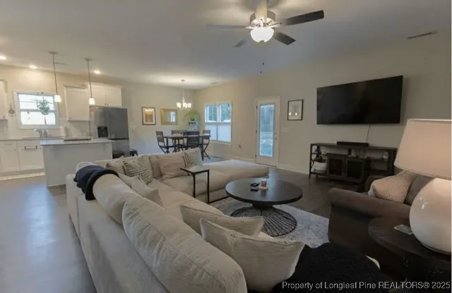 a living room with furniture and a flat screen tv