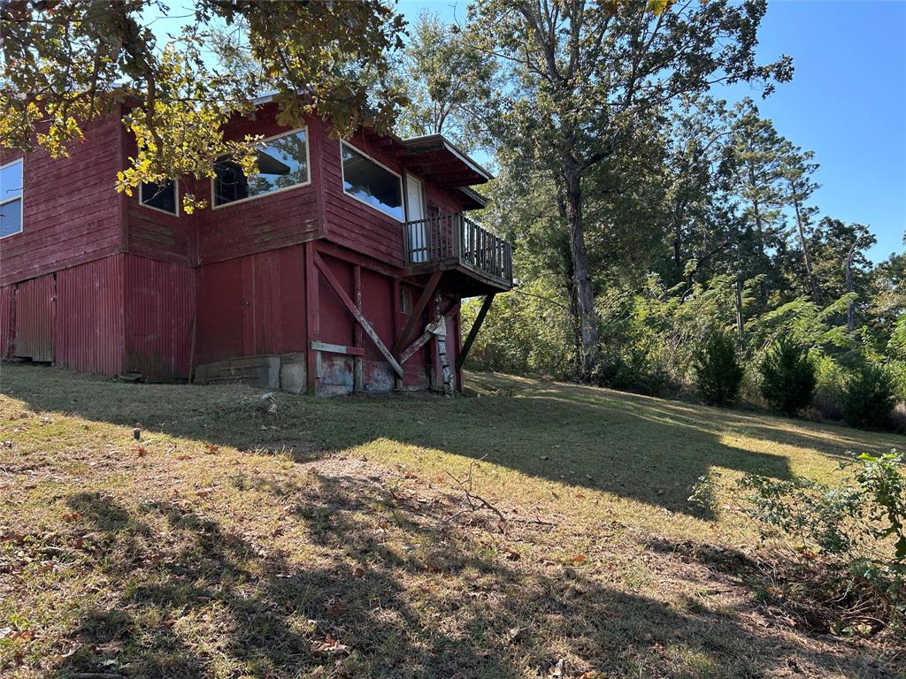 401 Ridge Row Many, LA 71449 - Photo 13 of 18 a view of a wooden house with a yard