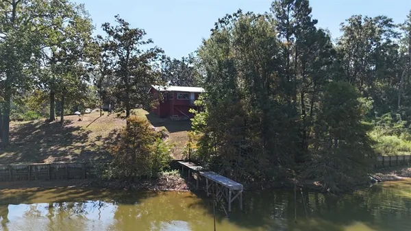 a view of river covered by trees and buildings