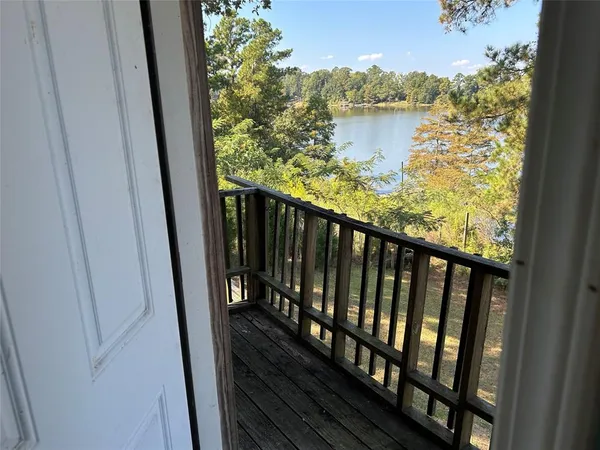 a view of balcony with wooden floor and lake view
