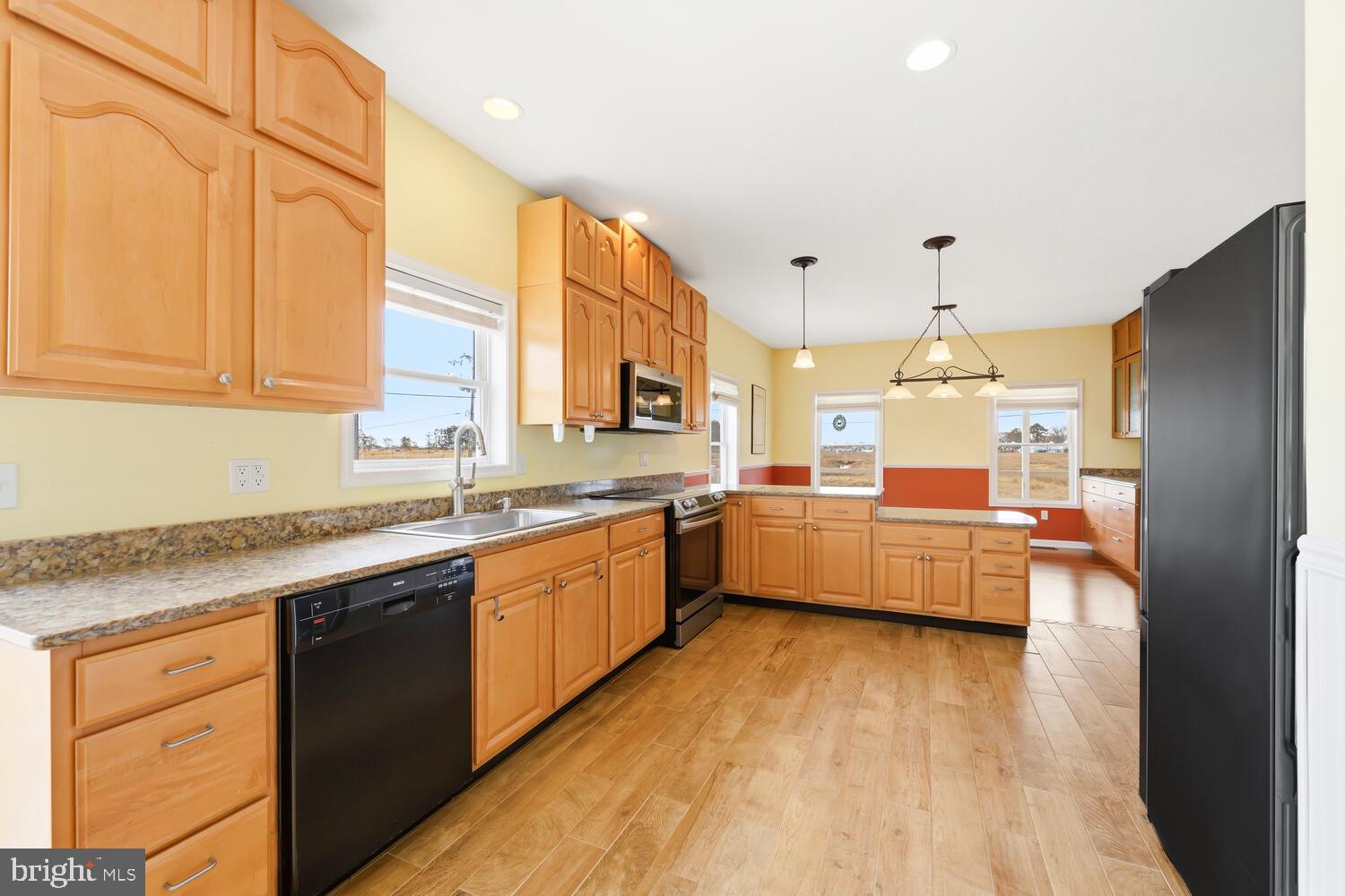 2576 Hoopers Island Road Fishing Creek, MD 21634 - Photo 16 of 43 a kitchen with stainless steel appliances a sink cabinets and wooden floor