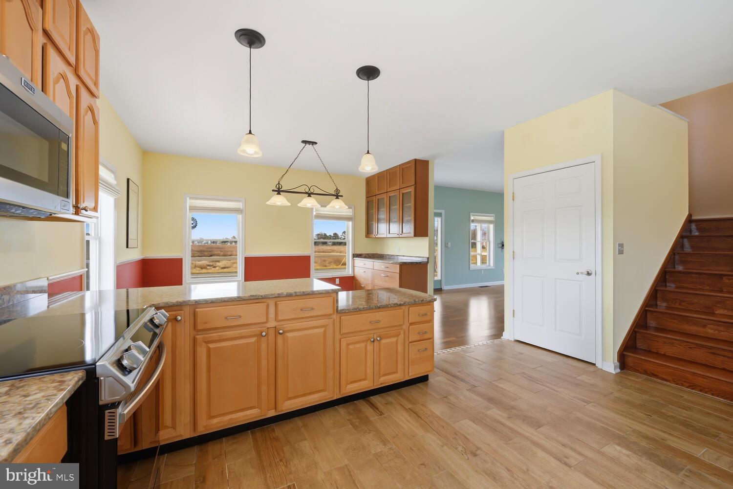 2576 Hoopers Island Road Fishing Creek, MD 21634 - Photo 17 of 43 a large kitchen with stainless steel appliances granite countertop a sink and wooden floor