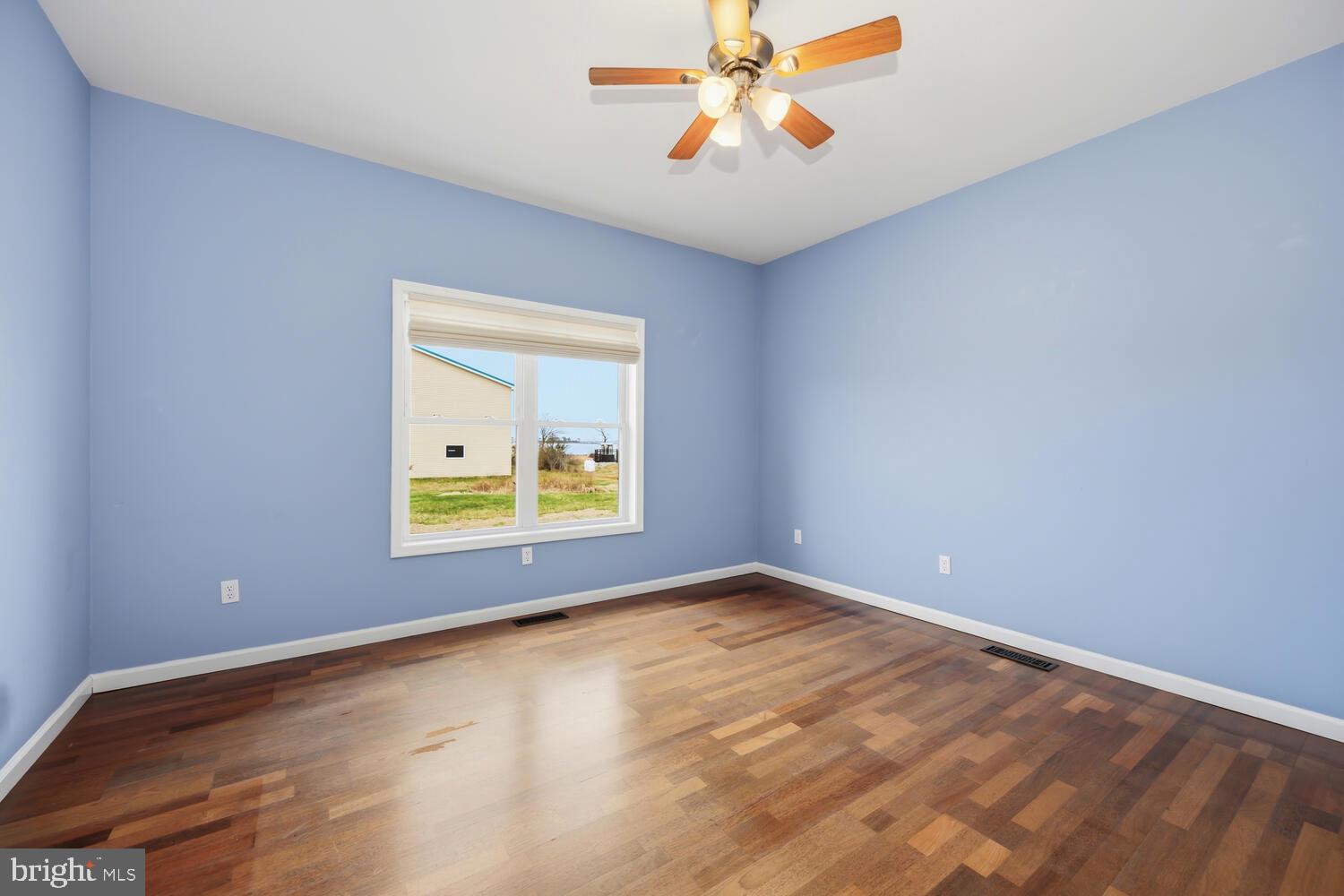 2576 Hoopers Island Road Fishing Creek, MD 21634 - Photo 18 of 43 an empty room with a window and a ceiling fan